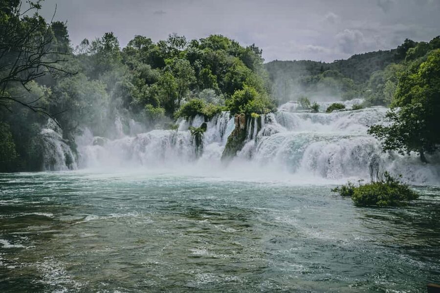 Makarska: Krka National Park Day Trip with Šibenik Visit - Entering Krka National Park: lakes, waterfalls, and wooden paths